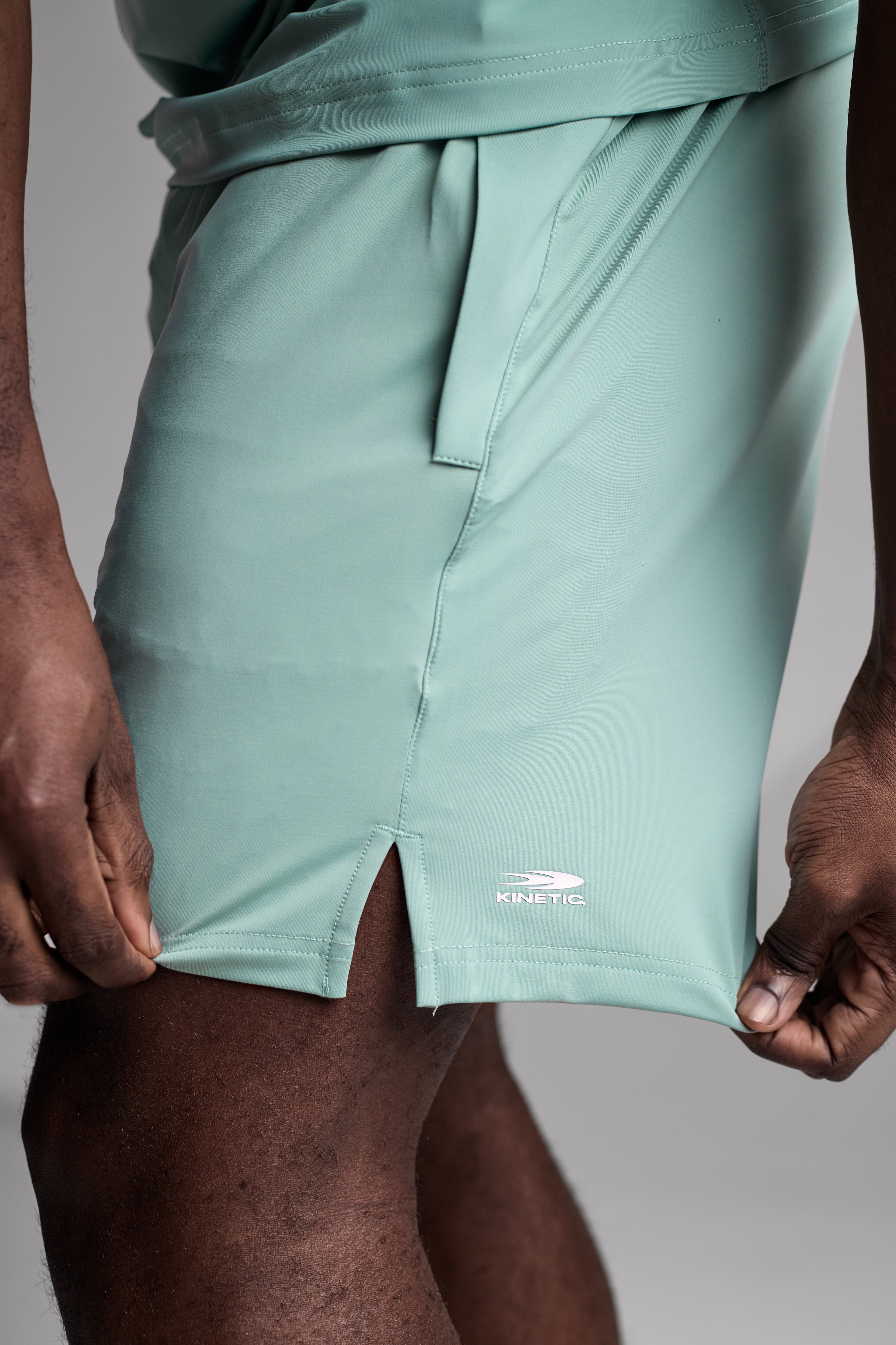Light green shorts with kinetic logo on a neutral background