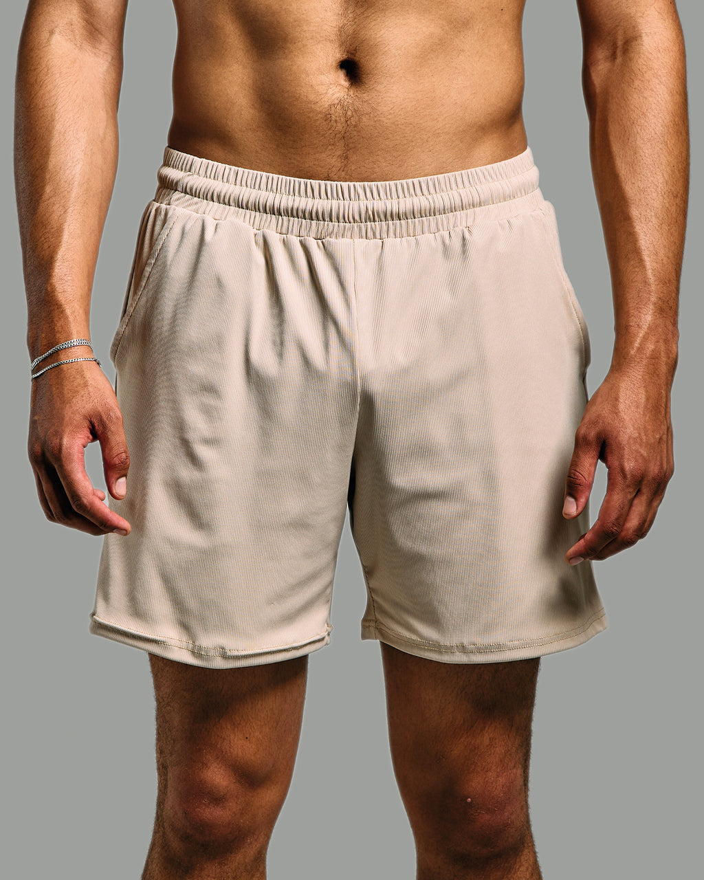 nude shorts worn by a person on a gray background